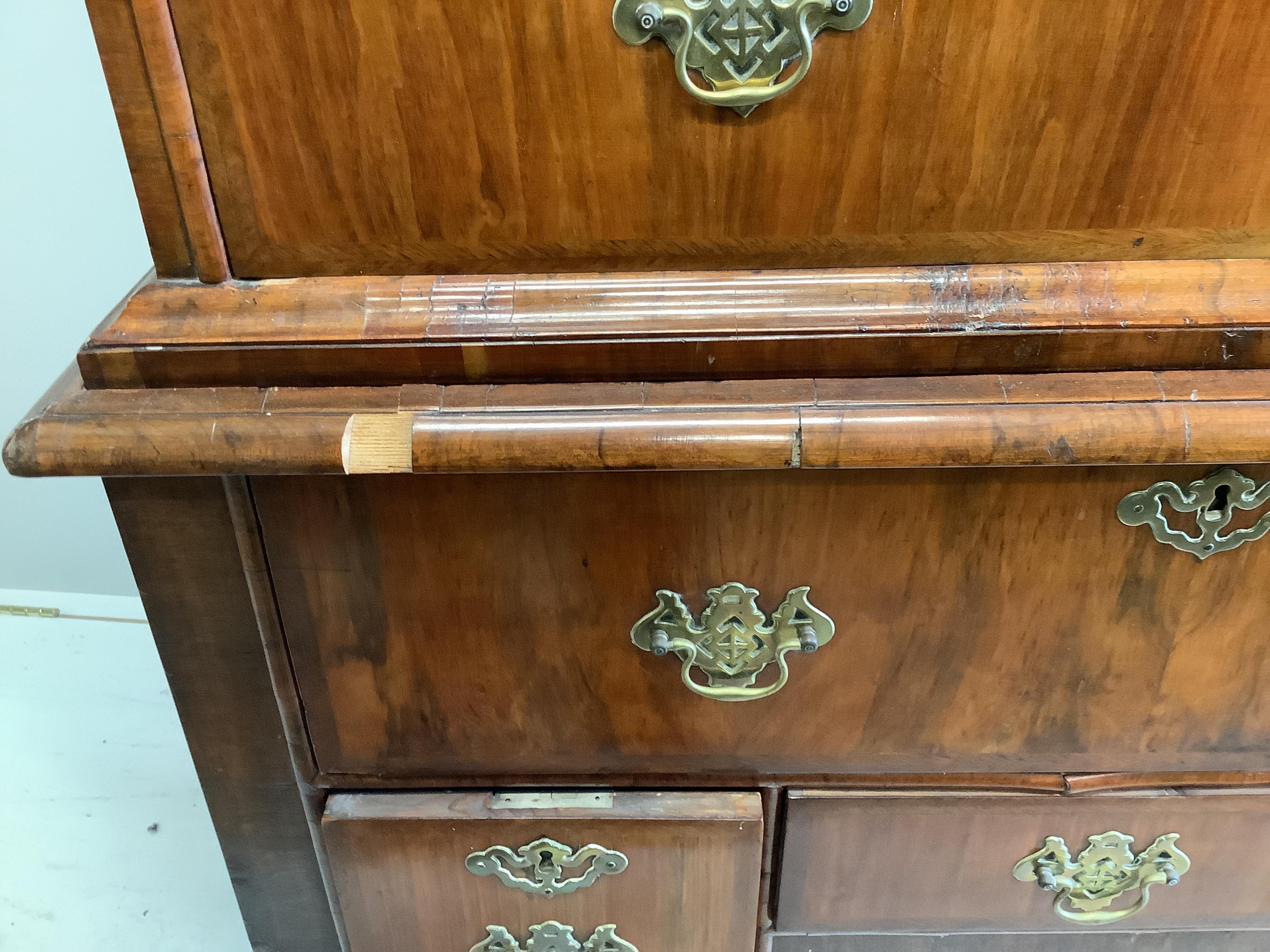 A George I and later feather banded walnut chest on stand, width 103cm, depth 58cm, height 167cm